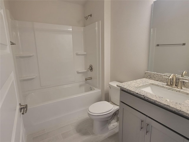 full bathroom featuring tile patterned flooring, vanity, toilet, and shower / washtub combination