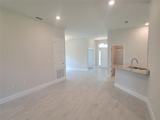 interior space featuring sink and light hardwood / wood-style flooring