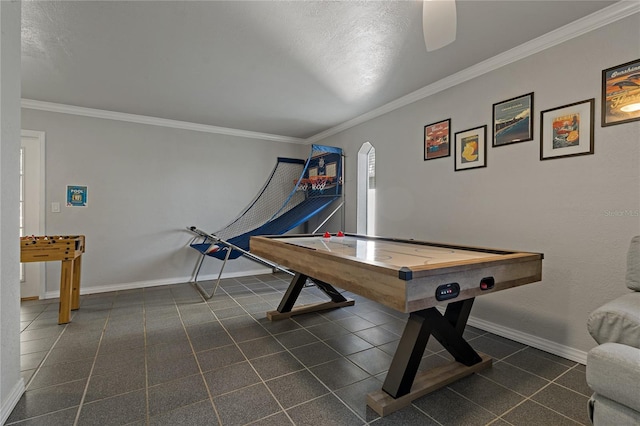 playroom with a textured ceiling, ceiling fan, and ornamental molding