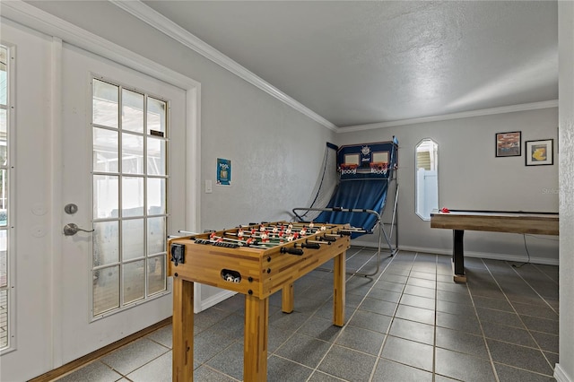 game room with ornamental molding and a textured ceiling