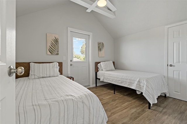 bedroom with ceiling fan, lofted ceiling, and wood-type flooring