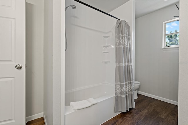 bathroom featuring shower / bathtub combination with curtain, toilet, and hardwood / wood-style floors