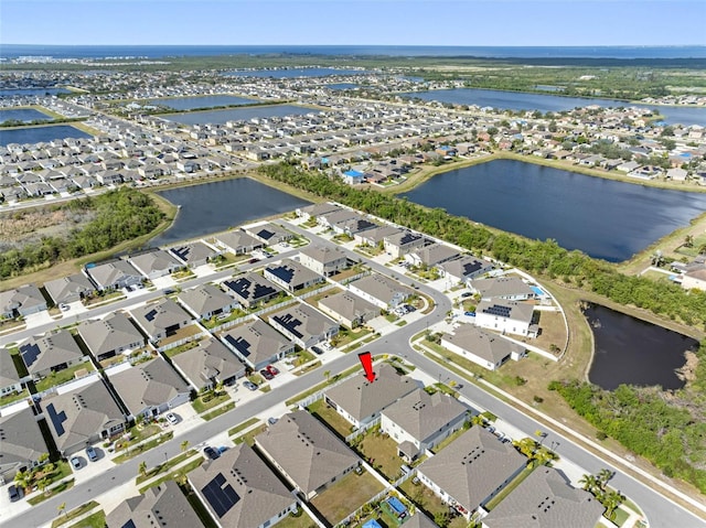 birds eye view of property with a water view