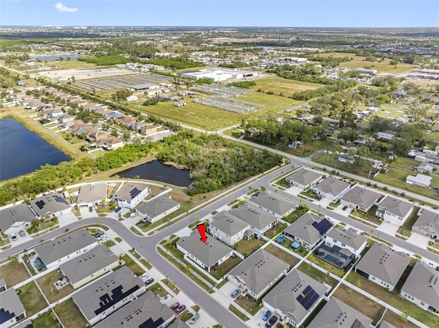 birds eye view of property with a water view