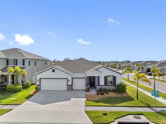 view of front of property with a garage and a front lawn