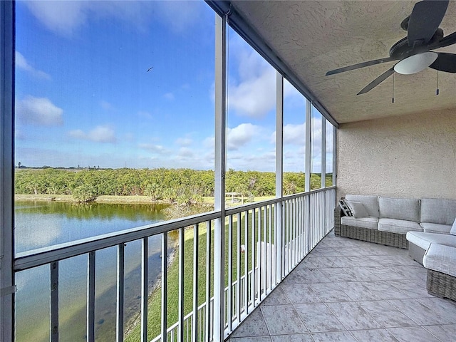 unfurnished sunroom with a water view and ceiling fan