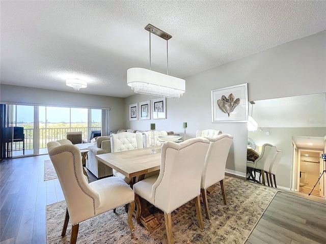 dining room featuring a textured ceiling and hardwood / wood-style flooring