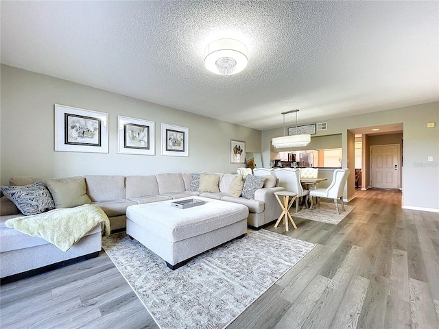 living room with hardwood / wood-style floors and a textured ceiling