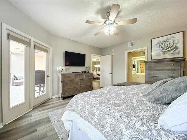 bedroom featuring access to exterior, a textured ceiling, light hardwood / wood-style flooring, and ceiling fan