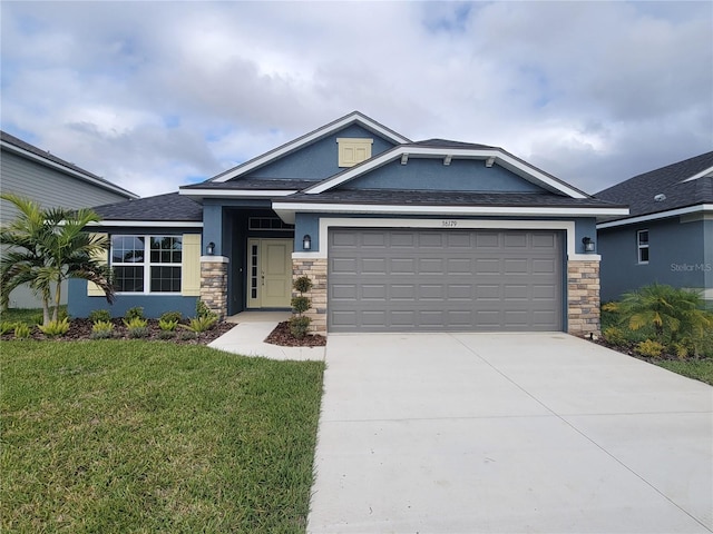 view of front of house featuring a garage and a front lawn