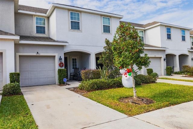 view of front facade featuring a front yard and a garage