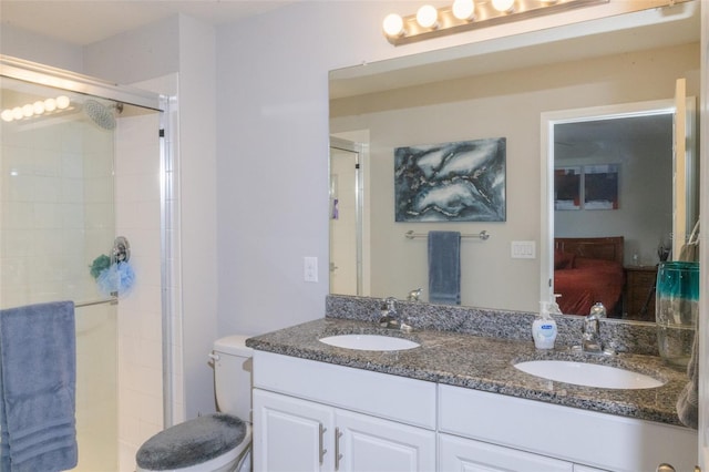 bathroom featuring toilet, vanity, and walk in shower