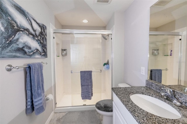 bathroom featuring walk in shower, vanity, and toilet