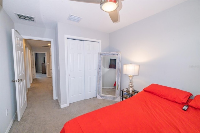 bedroom featuring a closet, ceiling fan, and light colored carpet