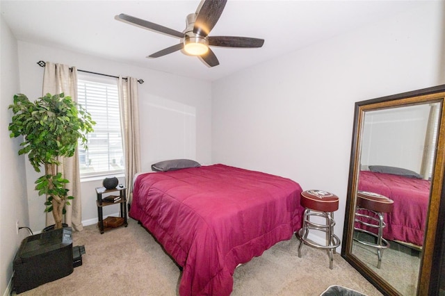 bedroom with ceiling fan, light carpet, and multiple windows