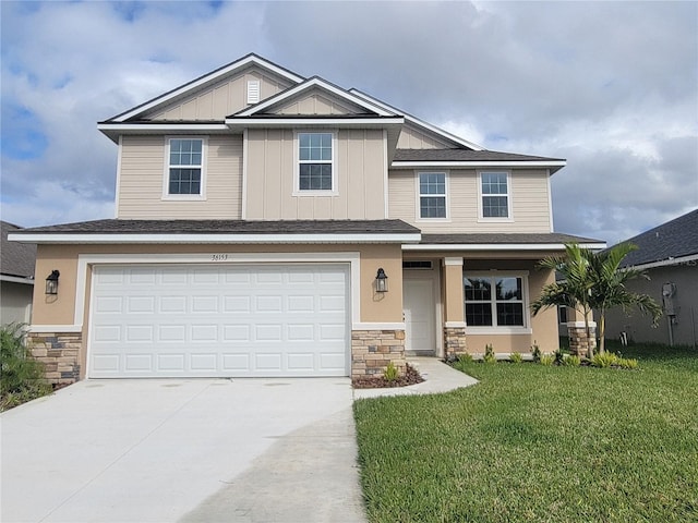 view of front of home with a front lawn and a garage