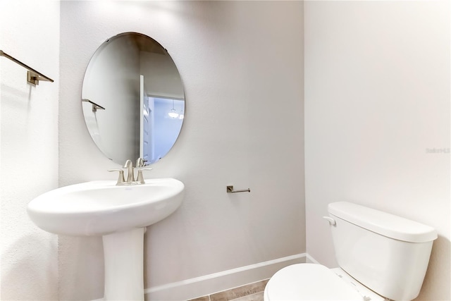 bathroom featuring tile patterned floors, toilet, and sink