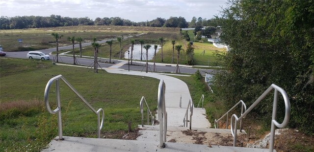 view of home's community featuring a yard, a water view, and a rural view