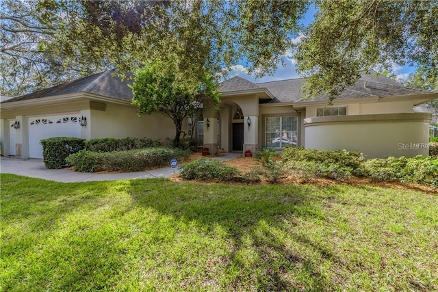 ranch-style home featuring a garage and a front lawn