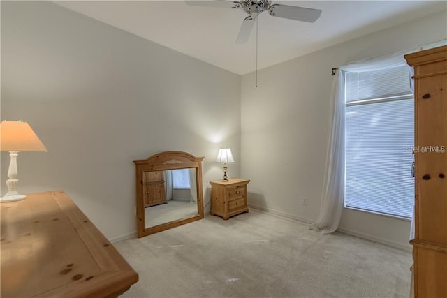 bedroom with light colored carpet and ceiling fan