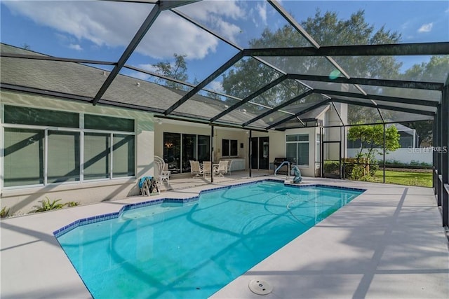 view of pool with a lanai and a patio