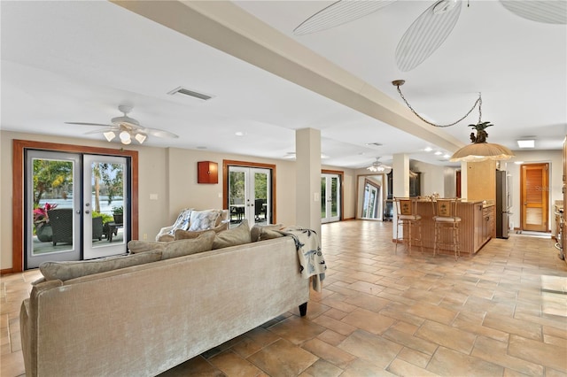 living room with french doors and ceiling fan