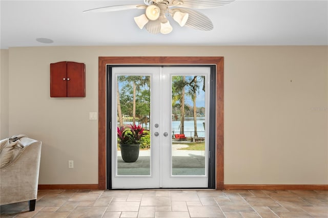 doorway featuring a water view, ceiling fan, and french doors