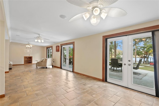 interior space with ceiling fan, french doors, and a healthy amount of sunlight