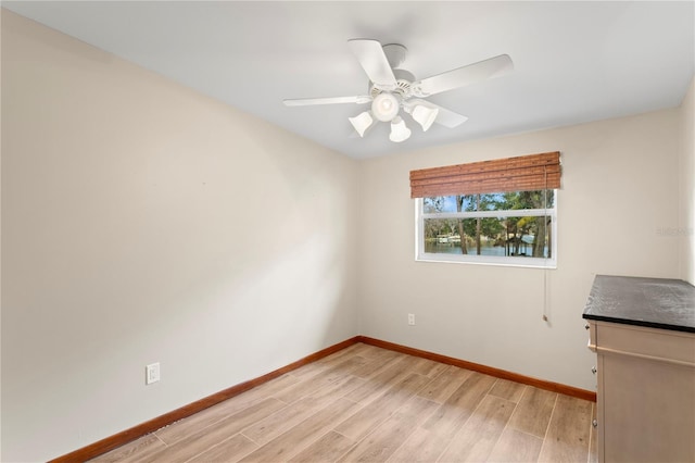 empty room with ceiling fan and light wood-type flooring