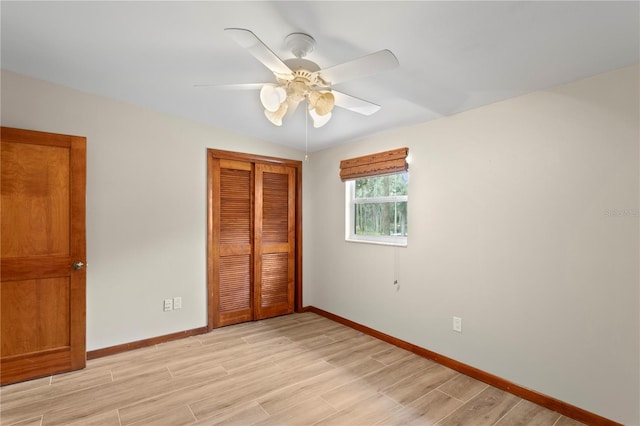 unfurnished bedroom featuring light hardwood / wood-style floors, a closet, and ceiling fan