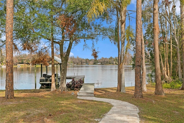 dock area featuring a water view and a yard