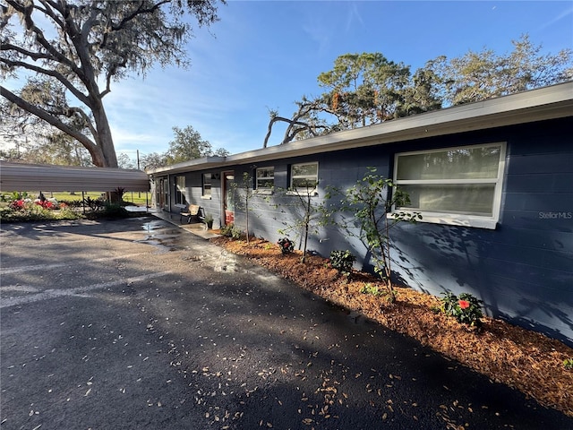 view of side of home featuring a carport