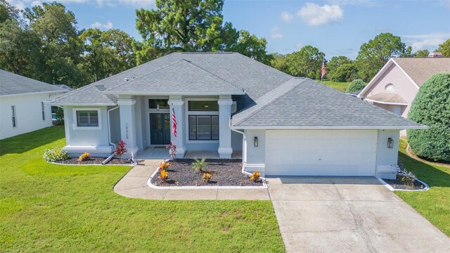 10328 Henderson St, Spring Hill, FL 34608 - view of front of property with a porch, a front yard, and a garage