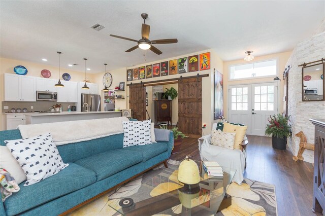 10328 Henderson St, Spring Hill, FL 34608 - living room with french doors, a barn door, hardwood / wood-style flooring, and ceiling fan