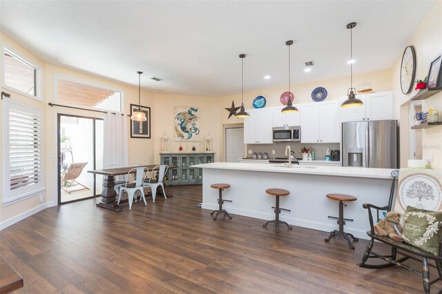 10328 Henderson St, Spring Hill, FL 34608 - kitchen featuring backsplash, stainless steel appliances, decorative light fixtures, and a kitchen breakfast bar