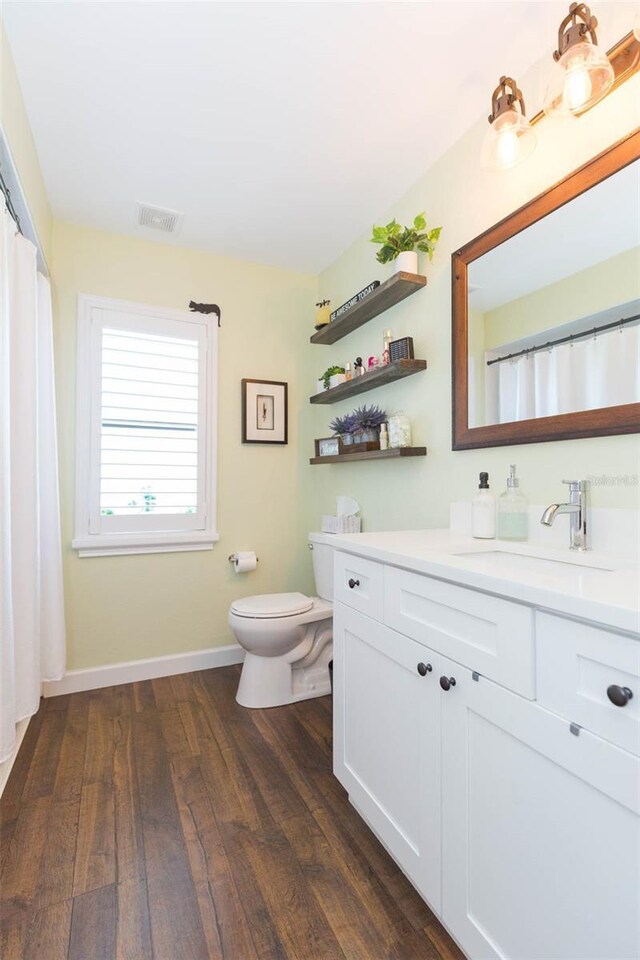 10328 Henderson St, Spring Hill, FL 34608 - bathroom with hardwood / wood-style floors, vanity, and toilet