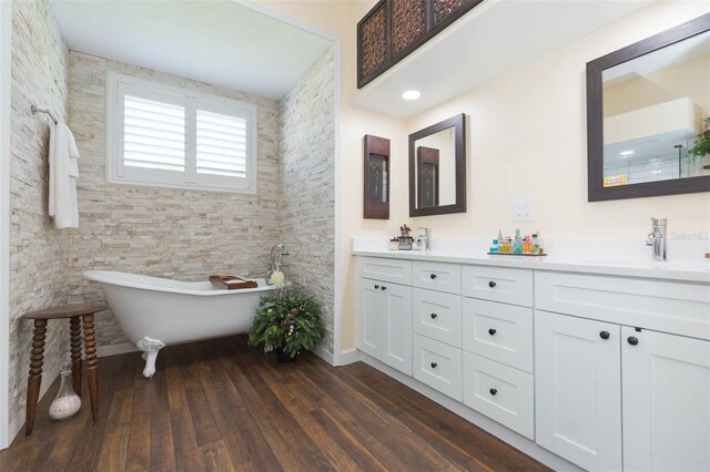 10328 Henderson St, Spring Hill, FL 34608 - bathroom featuring vanity, a bath, and hardwood / wood-style flooring