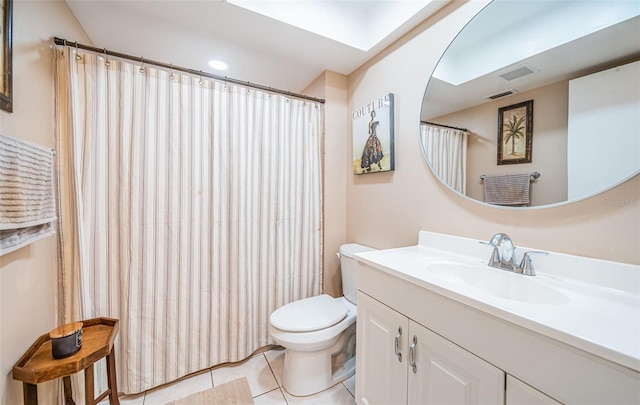 bathroom featuring tile patterned flooring, vanity, and toilet