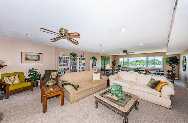 living room featuring light carpet and ceiling fan