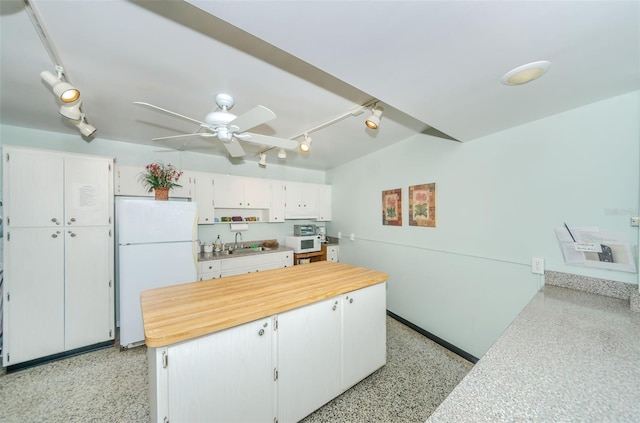 kitchen featuring white cabinets, ceiling fan, white appliances, and sink