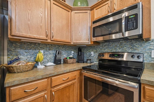 kitchen with appliances with stainless steel finishes and backsplash