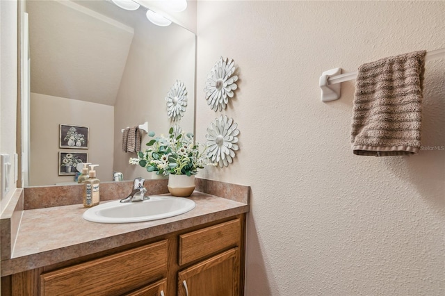 bathroom with vanity and vaulted ceiling