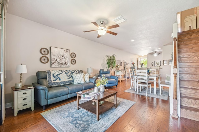 living room with ceiling fan and hardwood / wood-style floors