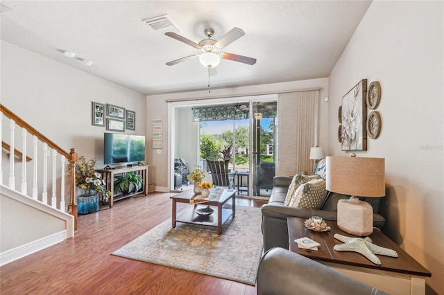 living room featuring ceiling fan and wood-type flooring