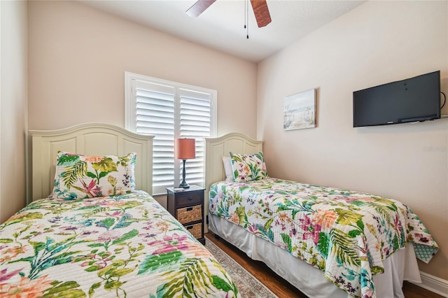 bedroom featuring ceiling fan and dark wood-type flooring