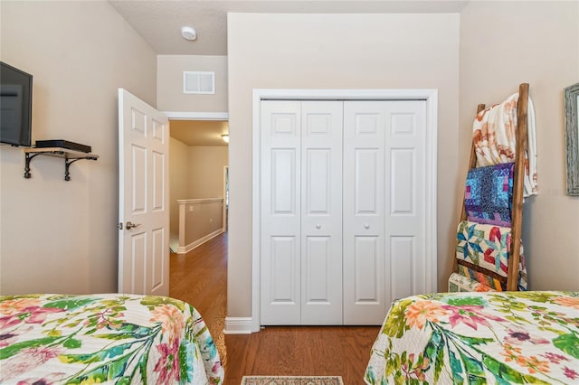 bedroom featuring hardwood / wood-style floors and a closet