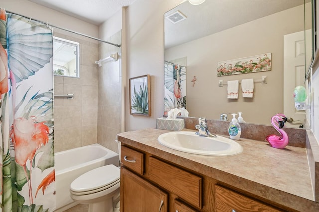 full bathroom featuring vanity, shower / tub combo, and toilet