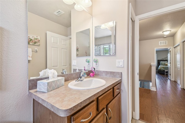 bathroom featuring vanity and wood-type flooring