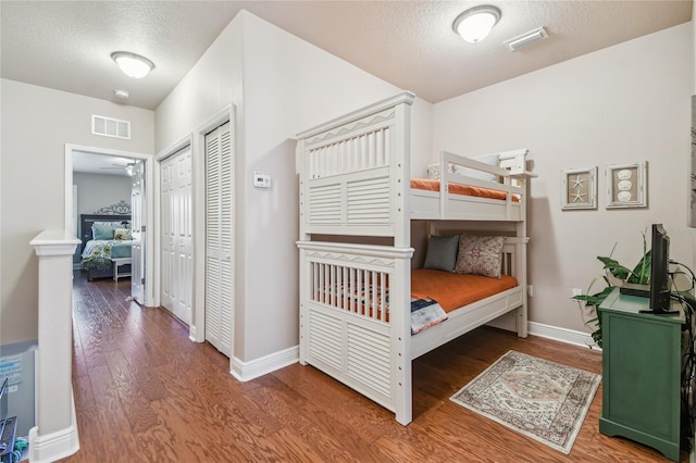 bedroom featuring hardwood / wood-style floors, a textured ceiling, and a closet