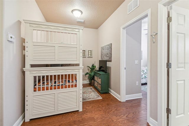 interior space featuring hardwood / wood-style floors and a textured ceiling